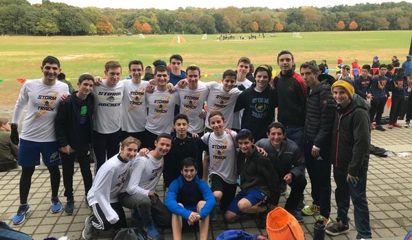 A track team poses together while wearing their matching custom gear after a race. 