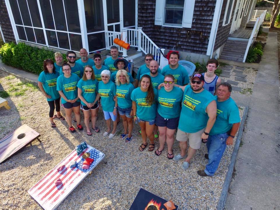 A group on vacation wears matching custom t-shirts for their annual cornhole tournament. 