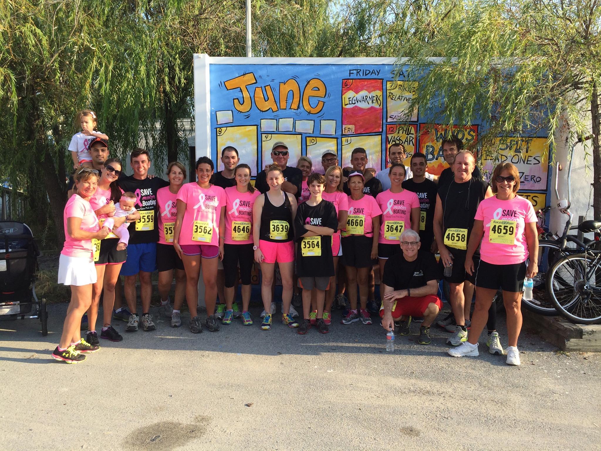 A group of people gather for a breast cancer walk/run wearing matching custom t-shirts. 