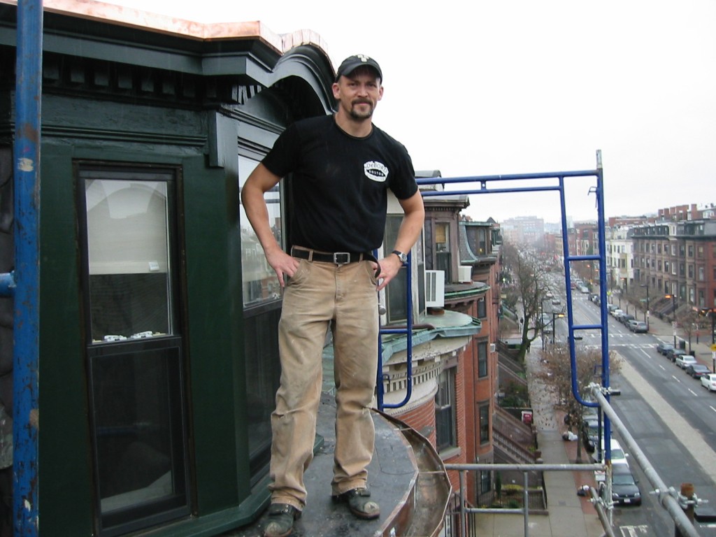 A construction worker poses while wearing their custom t-shirts. 