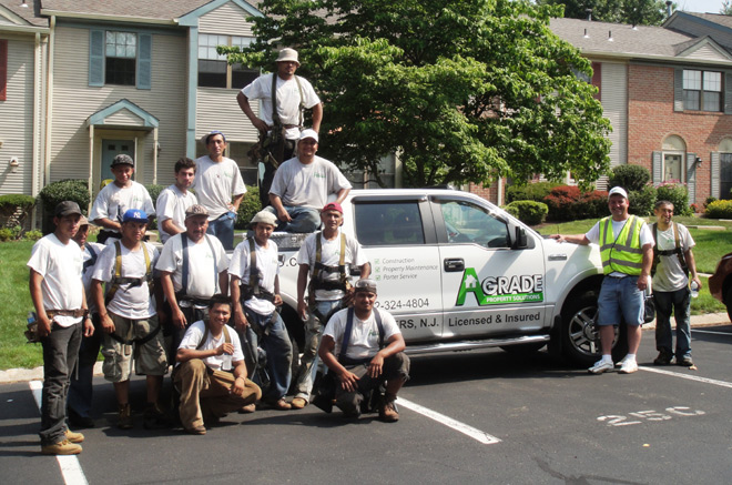 A group of construction workers pose while wearing their custom t-shirts. 