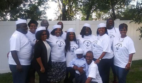 A family celebrating the life of their late family member who served in the Navy with matching custom t-shirts. 