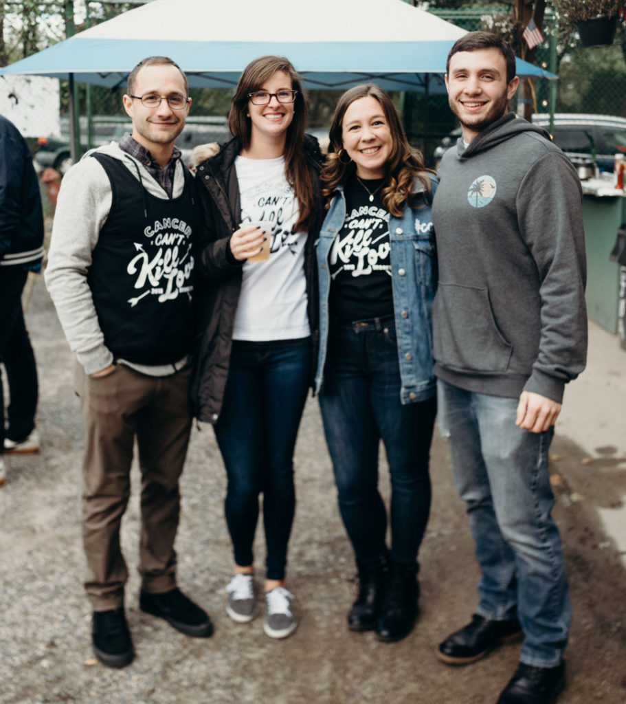 A group of people in matching custom shirts.