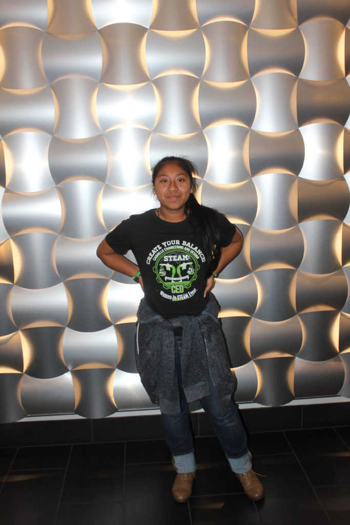 A student shows off her custom t-shirt while at a competition.