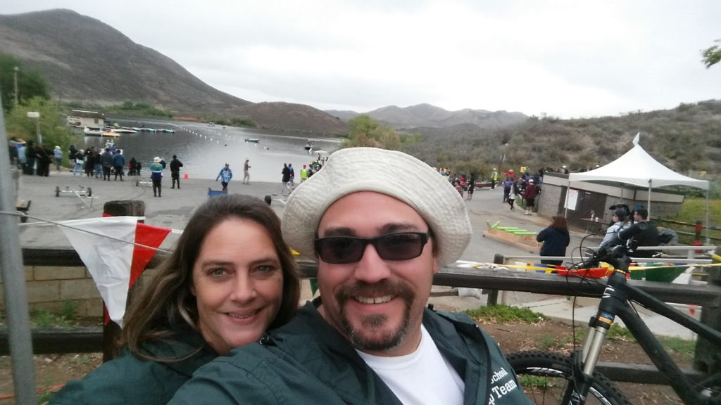 A man and his wife support a local team of students while wearing custom jackets.