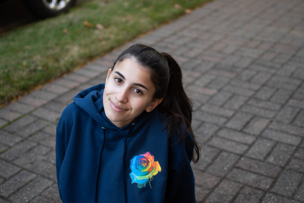 Dana wearing a hoodie with her rose drawing on it