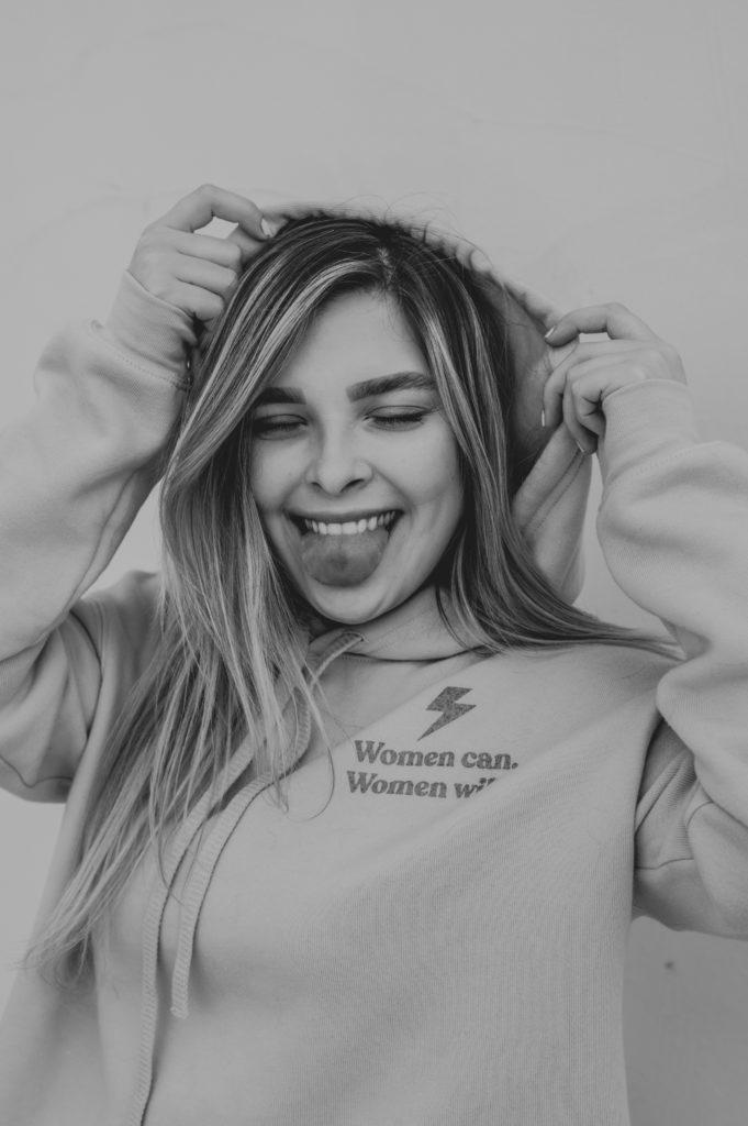 Becca playing around with her "Women Can. Women Will." cropped hoodie