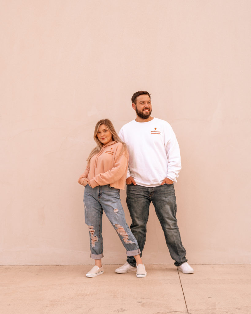 Becca and a male friend posing in their matching "Women Can. Women Will." custom apparel