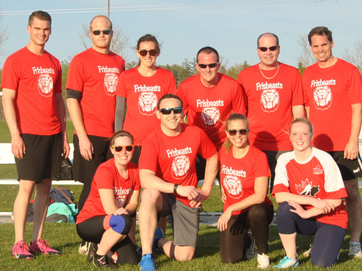 A Kan Jam team wearing custom t-shirts with an image of a frisbee and the text Frisbeasts on them.