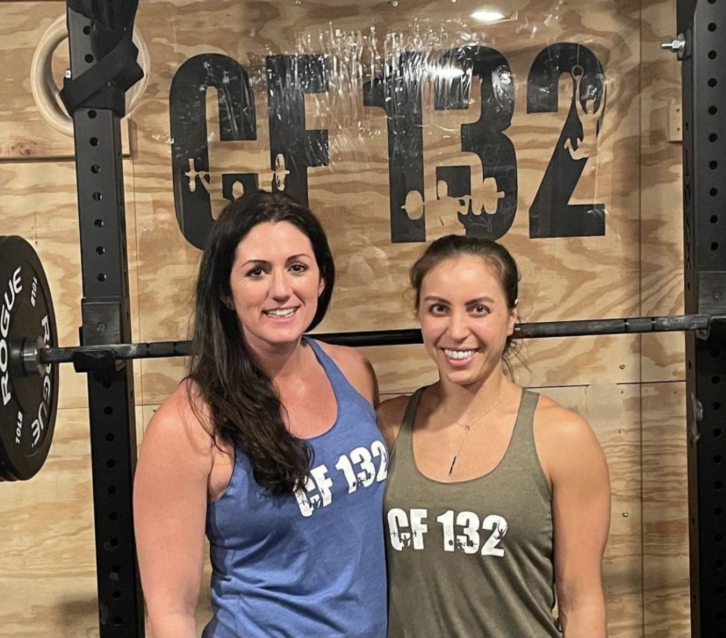 Two members of CF 132 showing off their custom tank tops