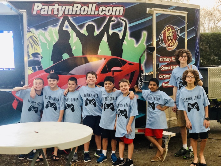 A group of kid gamers hang out in their custom t-shirts