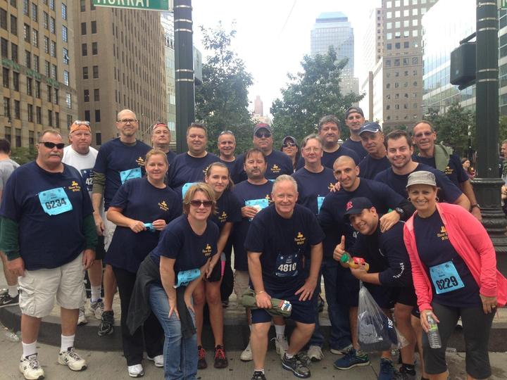 A group of Tunnel to Tower 5k runners wearing matching custom t-shirts