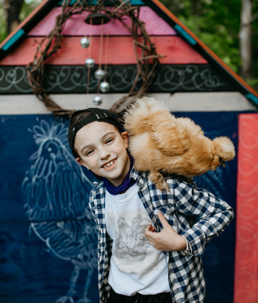 Boy in custom chicken shirt with chicken on his back