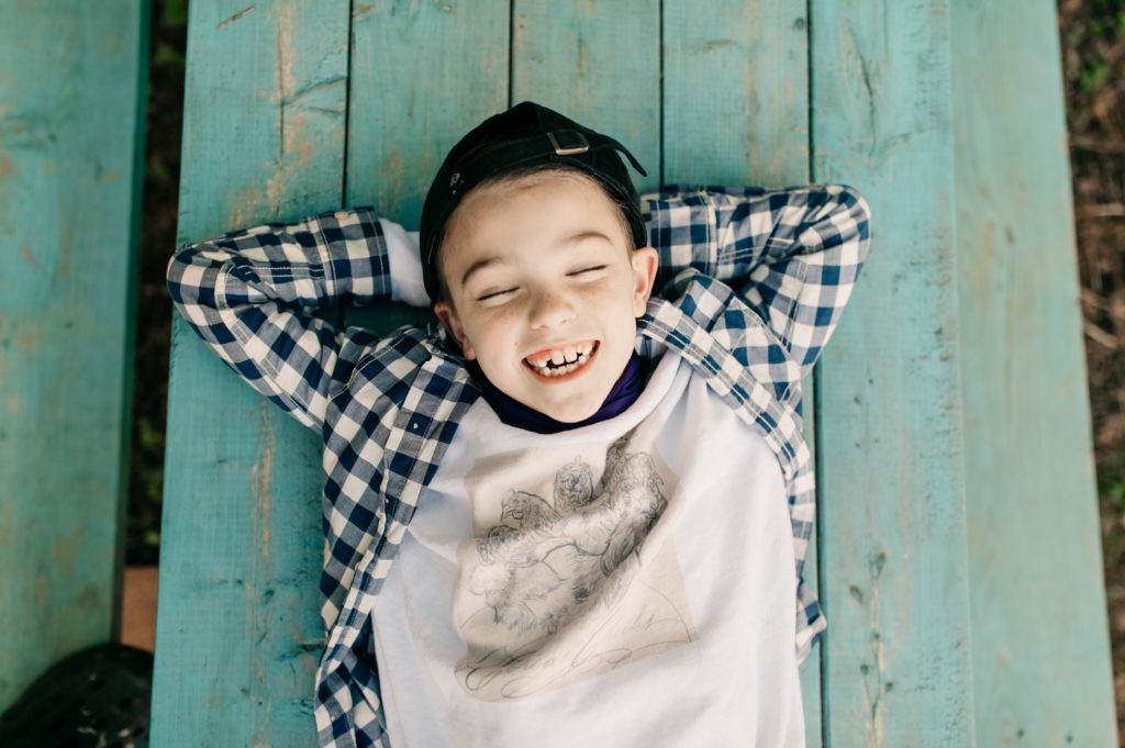 Boy wearing custom crewneck sweatshirt with art of chickens on the front