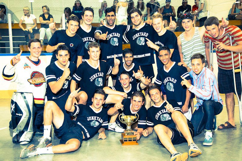 A group of hockey seniors celebrating a win together in custom t-shirts.