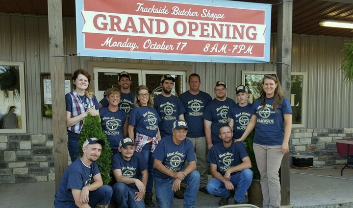 A group of butcher shop employees wearing matching custom shirts