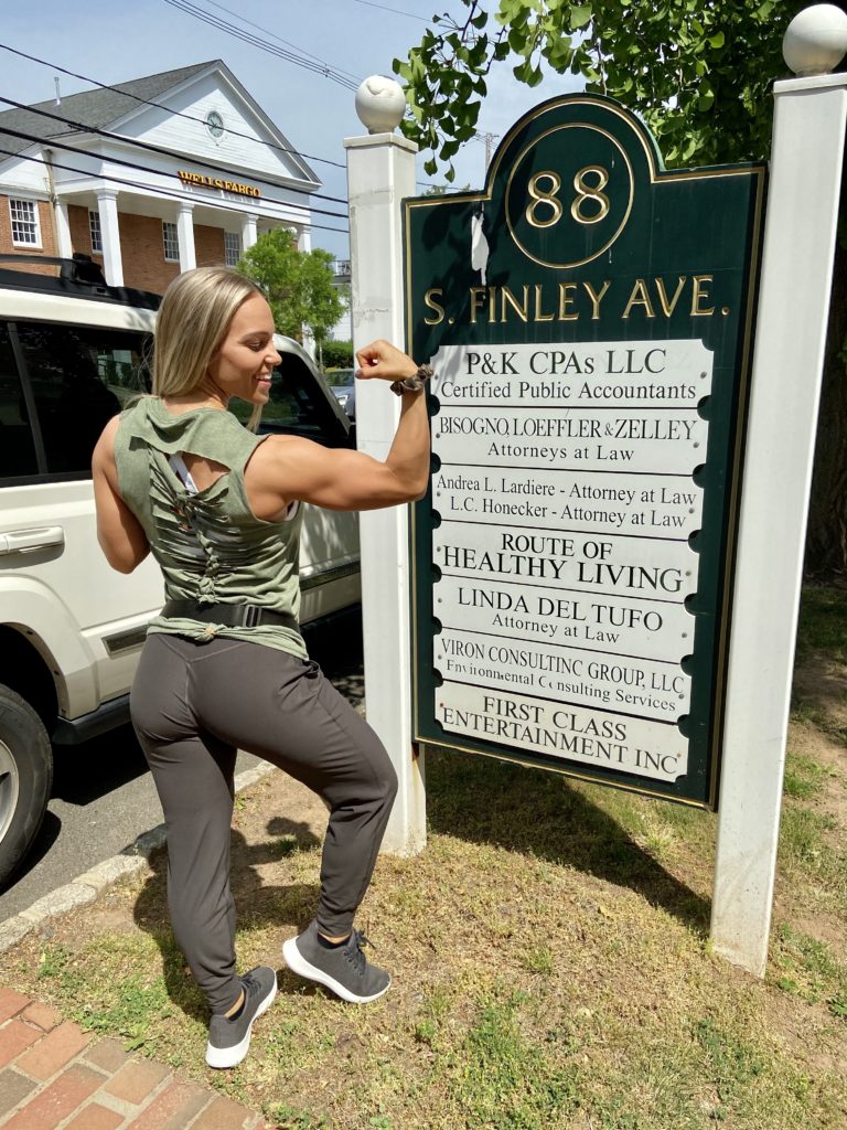 Muscular woman showing off her bicep and her customized t-shirt