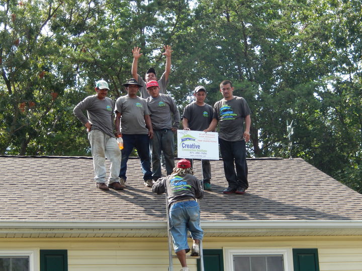 A gutter cleaning company wearing matching custom t-shirts.