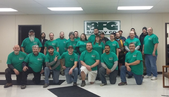 A christmas light hanging company shows off their matching custom t-shirts.