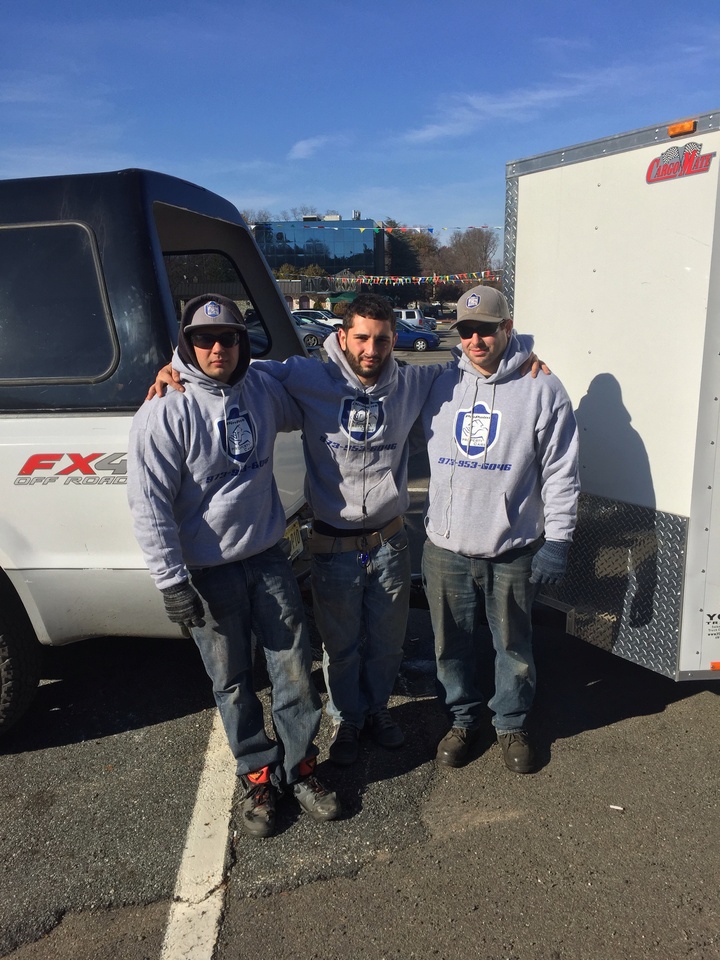 A snow plow company wearing matching custom sweatshirts.