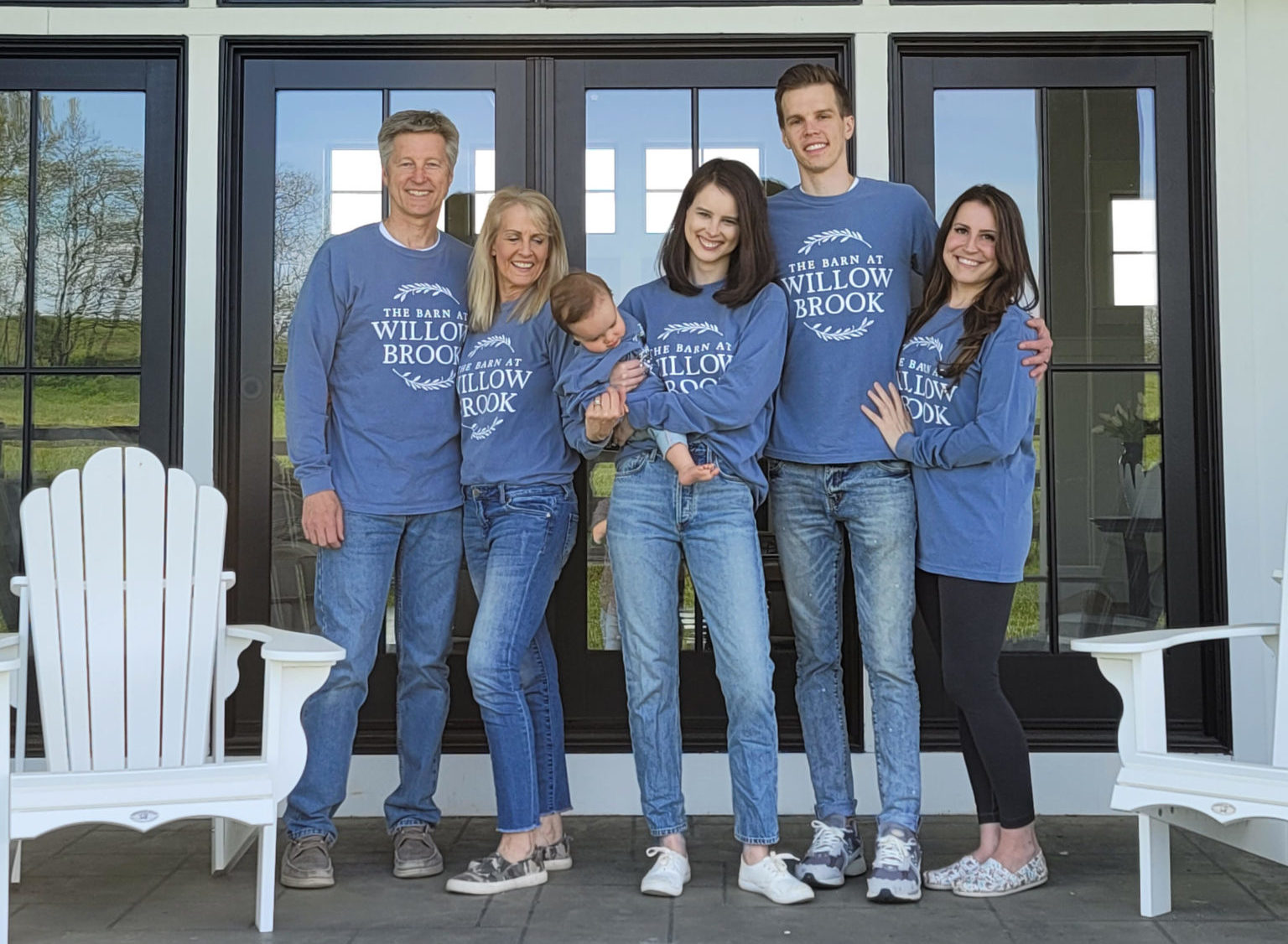 two men, three women, and a baby all wearing matching custom t-shirts