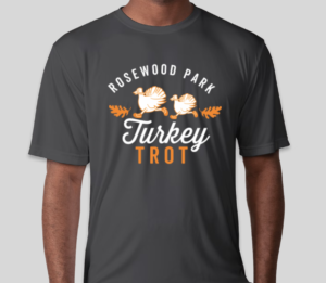 A charcoal gray performance t-shirt with an illustration of two turkeys wearing running shoes and the text "Rosewood Park Turkey Trot." 