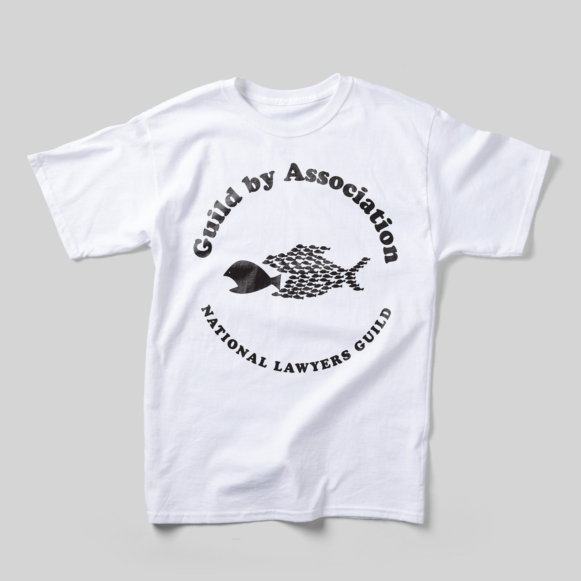 A white t-shirt that reads "Guild by Association: National Lawyers Guild" encircling an illustration of a school of fish about to swallow one large fish.