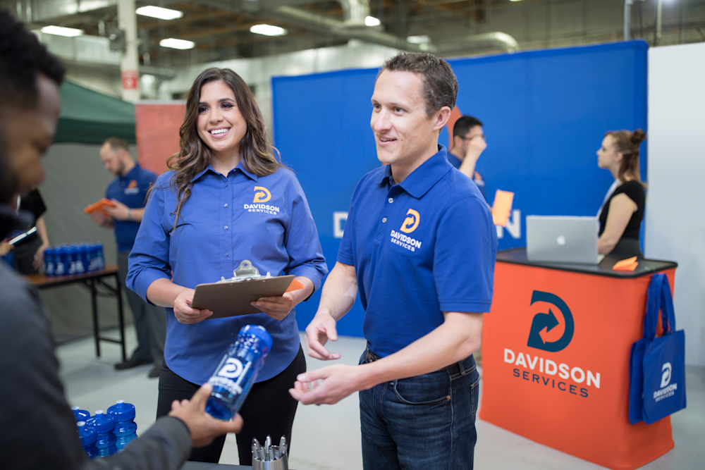employees at a trade show in custom apparel