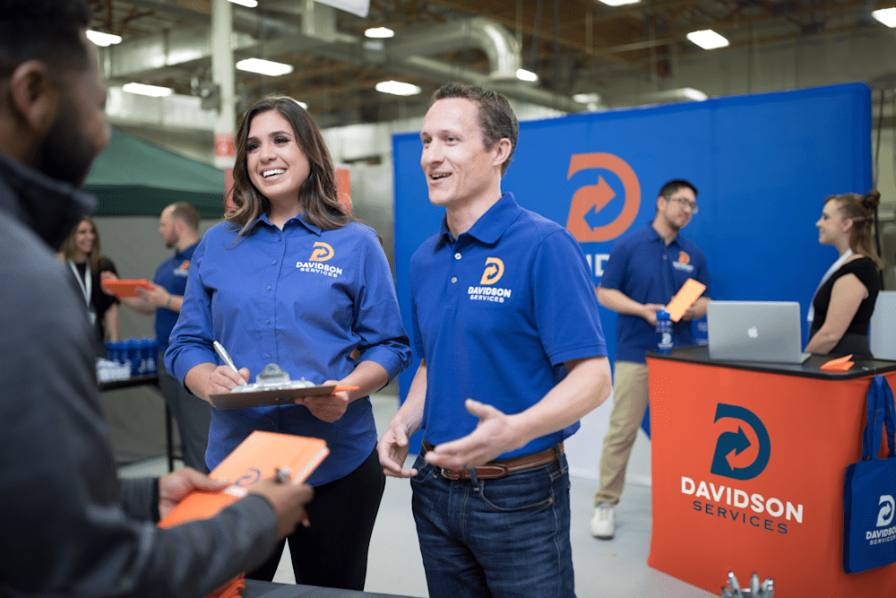employees at a trade show in custom apparel