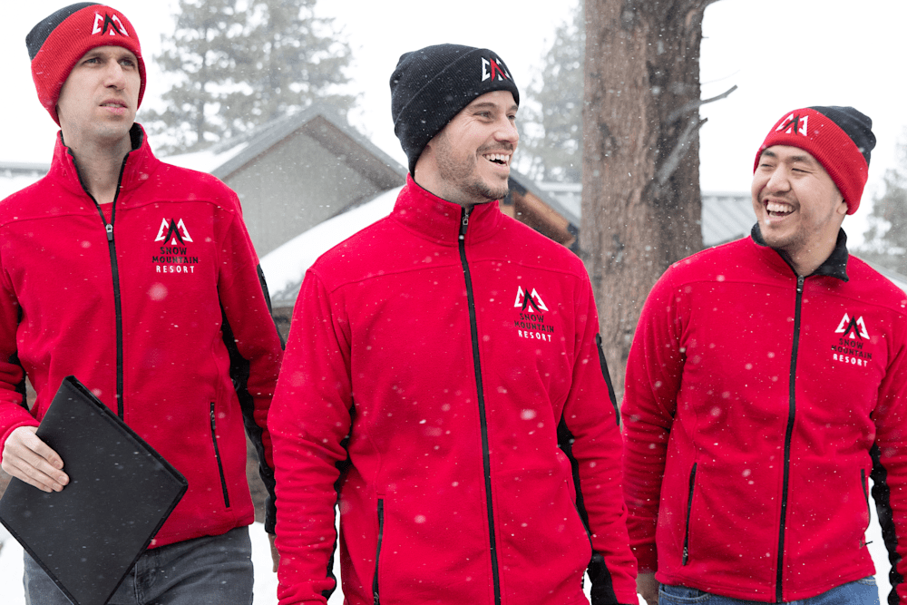 people wearing custom beanies in the snow